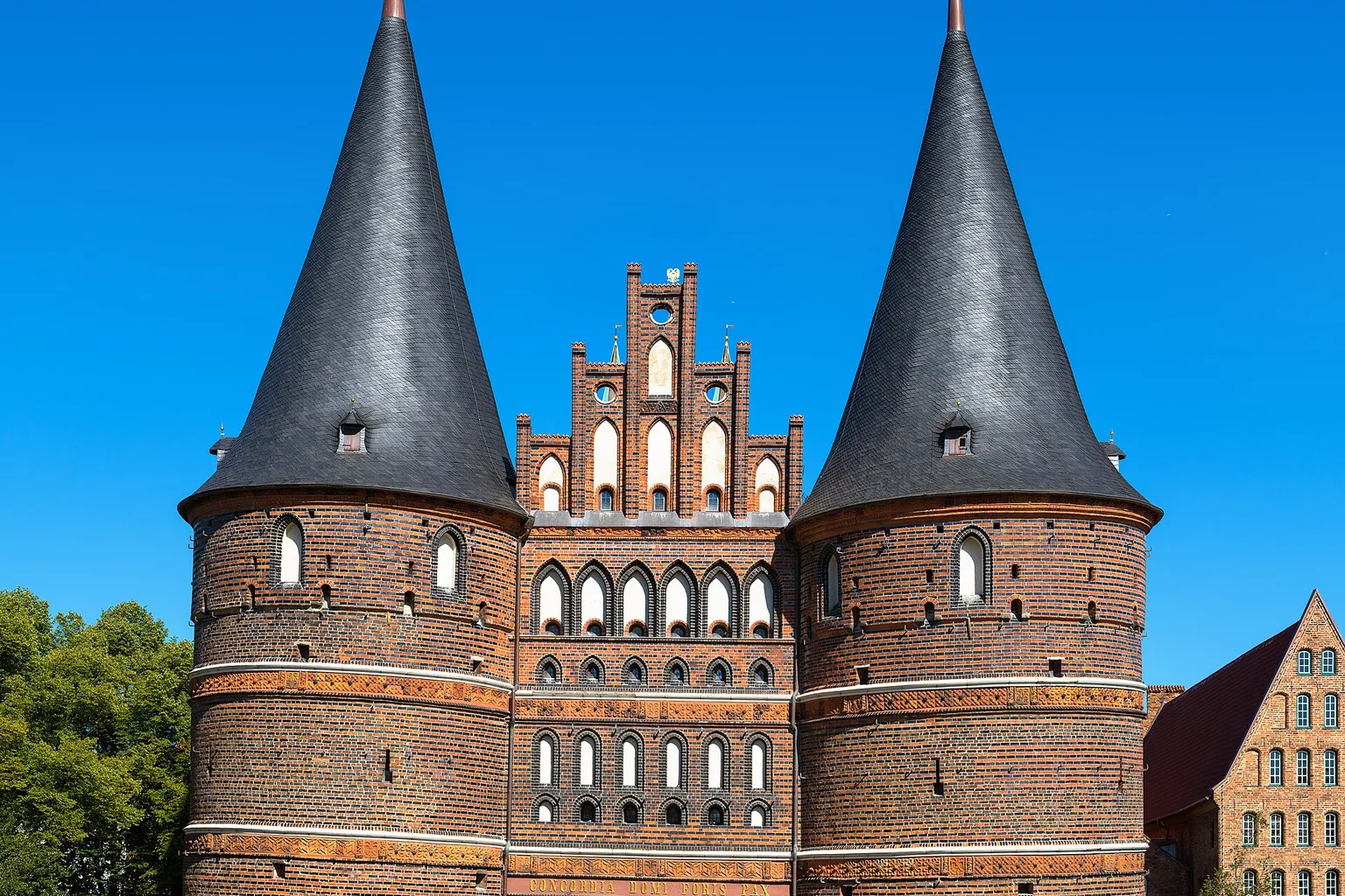 Holstentor in Lübeck, Germany. View from Holstenplatz. Next to the gate (right) the historical Salzspeicher.